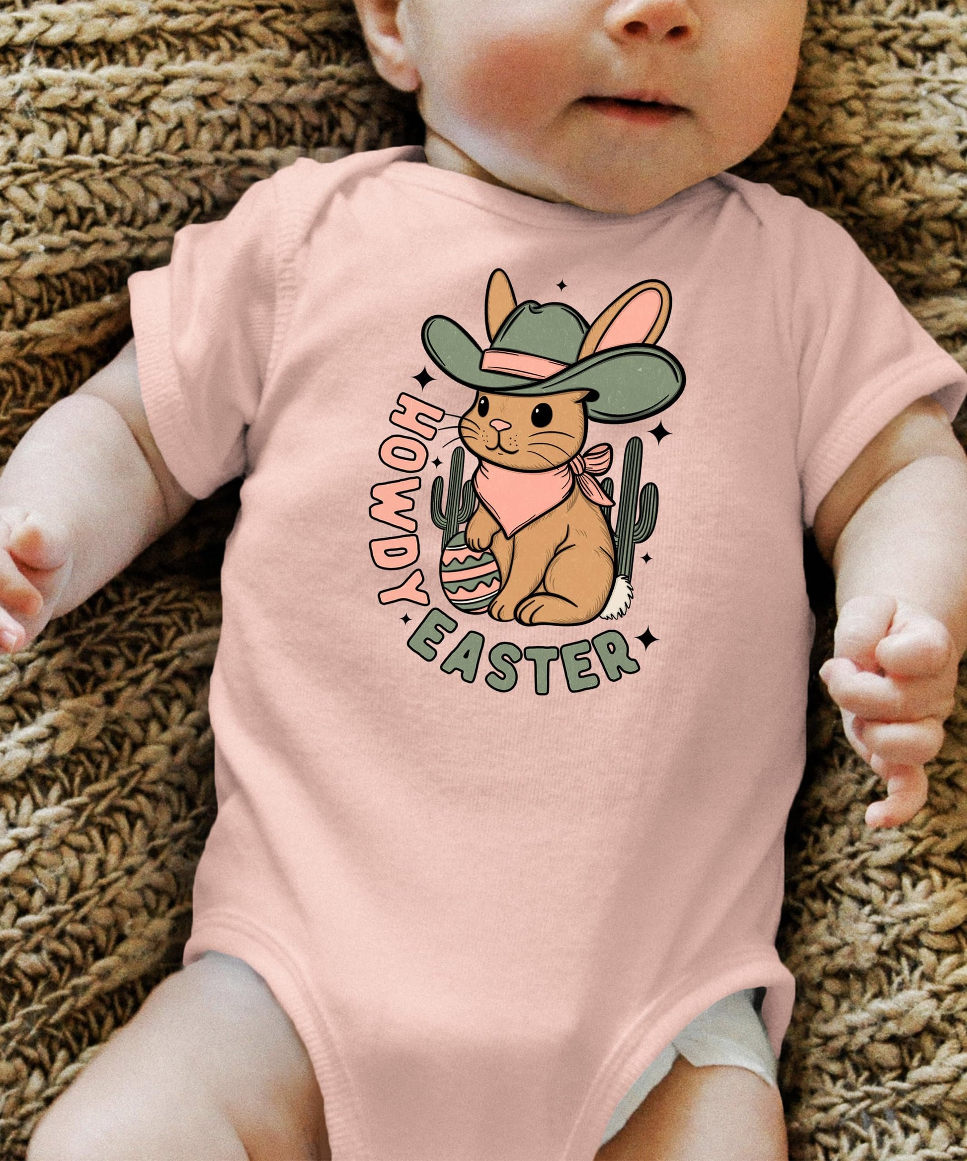 Flat lay of Olive Loves Apple peach Easter bodysuit with western bunny design