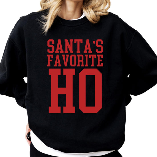 White sweatshirt with Santa's Favorite Ho text in red and green holiday lettering