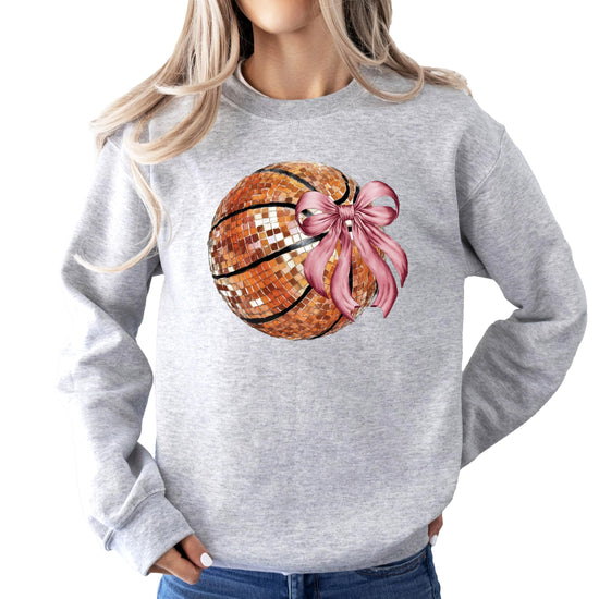 Women's gray pullover sweatshirt with a disco basketball and pink coquette bow graphic printed on the front