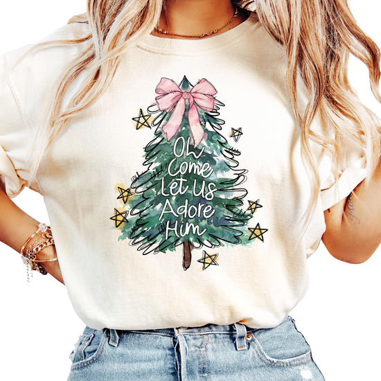 Close-up of Christmas tree with pink bow topper print on seafoam women's holiday shirt