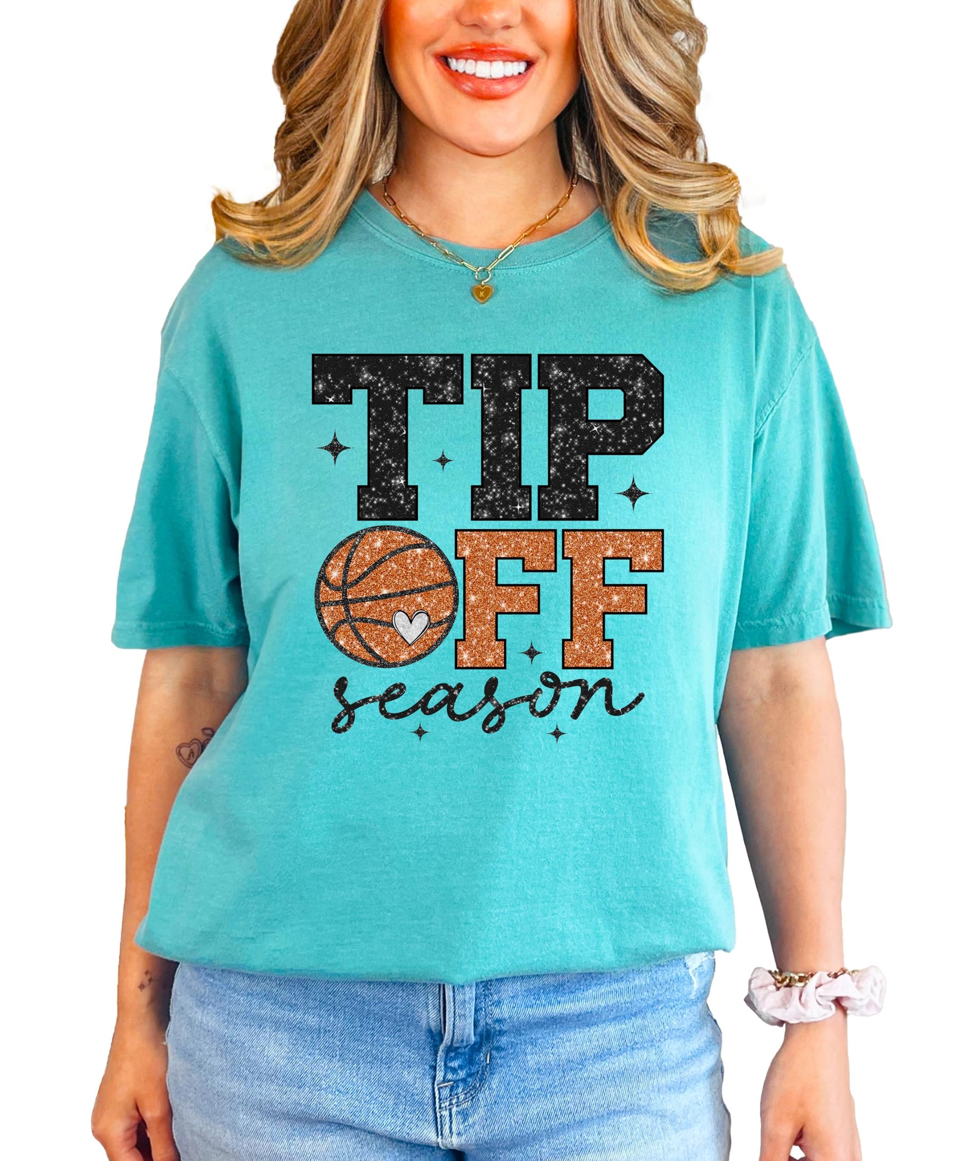 Close-up of faux glitter basketball and heart graphic on women's graphic tee