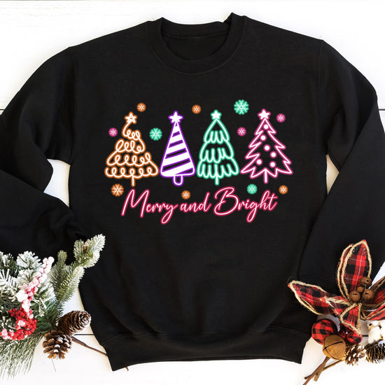 Women's Merry and Bright black sweatshirt with vibrant neon holiday tree design, front view