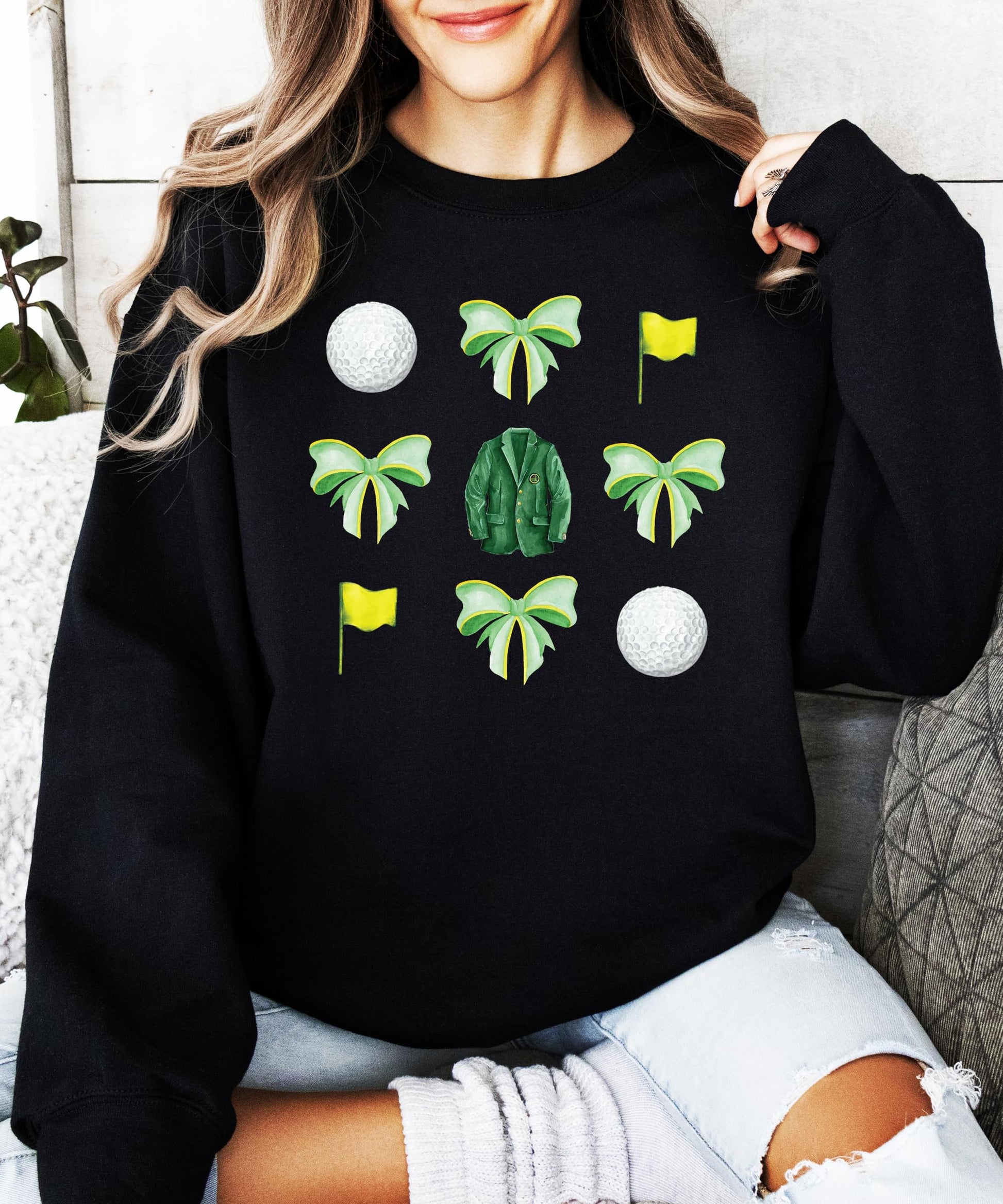 Lifestyle or detail shot of golf bows and balls graphic sweatshirt for women and teens