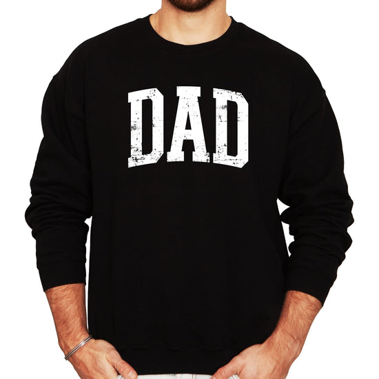 Close-up of distressed DAD graphic print on a gray men's crewneck sweatshirt
