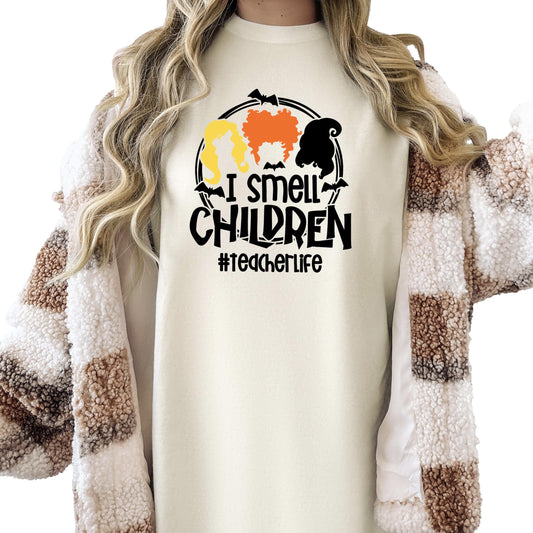 Front view of funny Halloween teacher tee with three witches design on ivory shirt