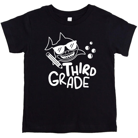 Close-up of vintage shark graphic print on blue boys back to school shirt