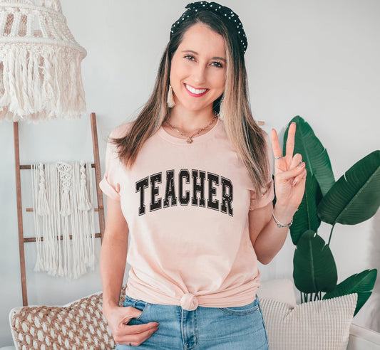 Collection of teacher varsity t-shirts in multiple colors - black, navy, and gray