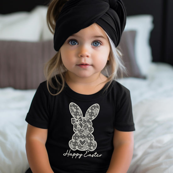 Girls Easter shirt flat lay showing bunny print and Happy Easter text