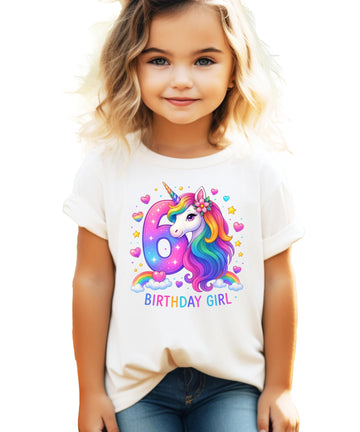 Front view of pink girls birthday shirt featuring colorful rainbow unicorn illustration