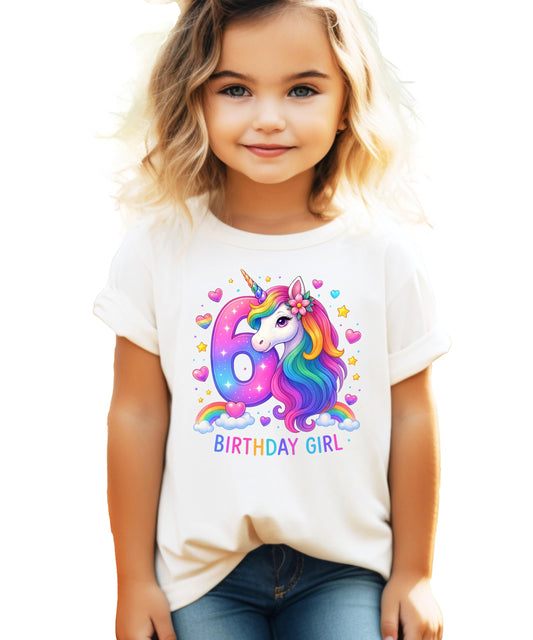 Front view of pink girls birthday shirt featuring colorful rainbow unicorn illustration