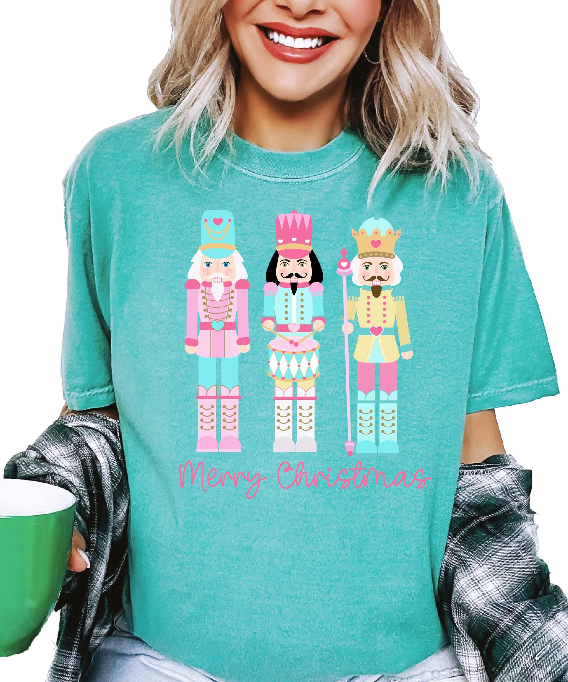 Side view of women's pastel nutcracker festive graphic tee in seafoam color