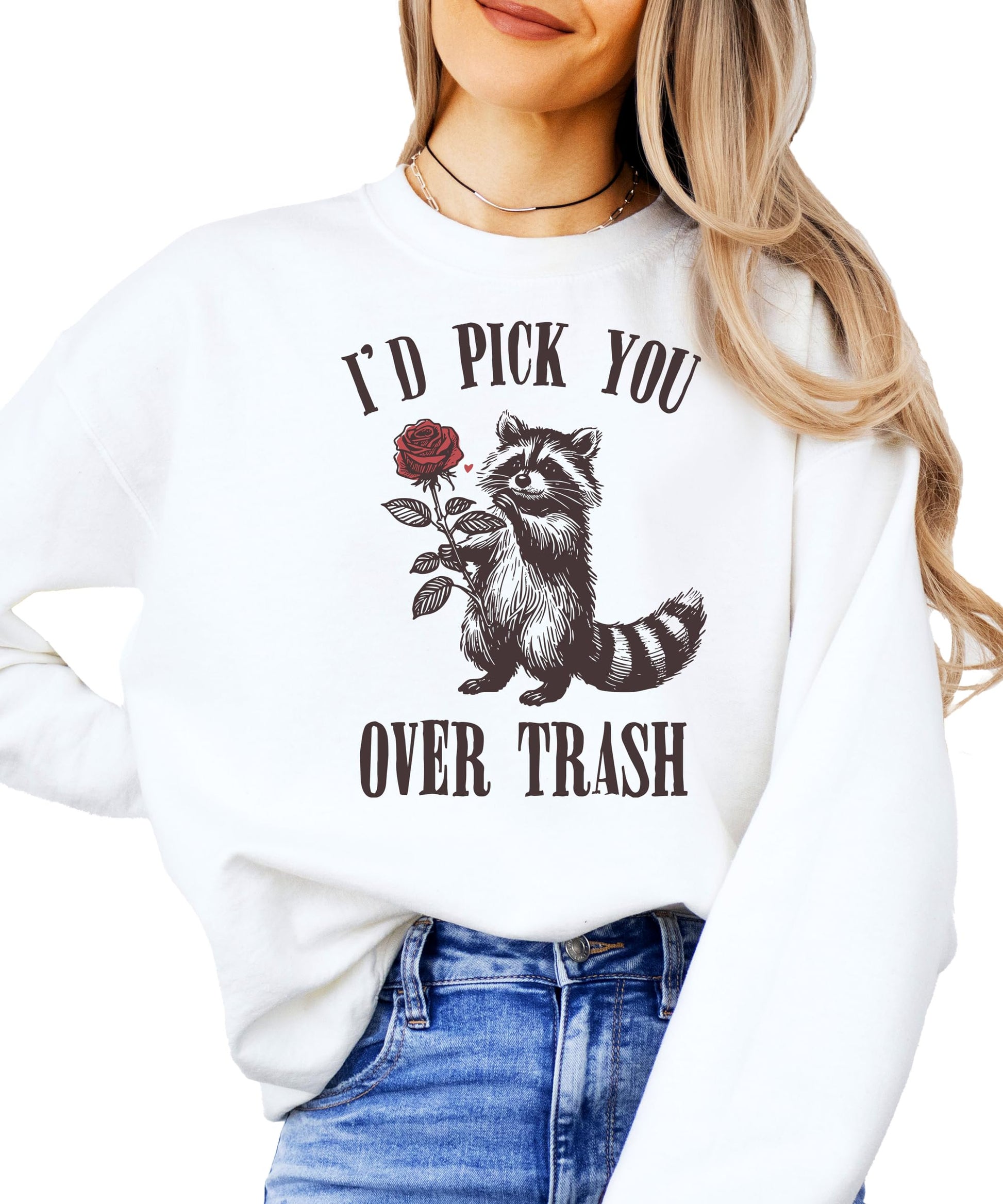 White sweatshirt with funny raccoon holding a rose graphic and text 'I'd Pick You Over Trash' for Valentine's Day