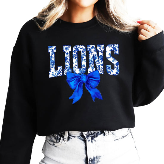 Front view of Lions coquette bow sweatshirt laid flat showing full graphic design