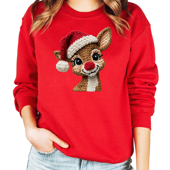 Close-up of festive reindeer yarn patch print on a cozy white holiday sweatshirt