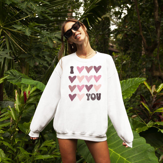 Front view of cozy Valentine's Day graphic sweatshirt from Olive Loves Apple with I Love You design