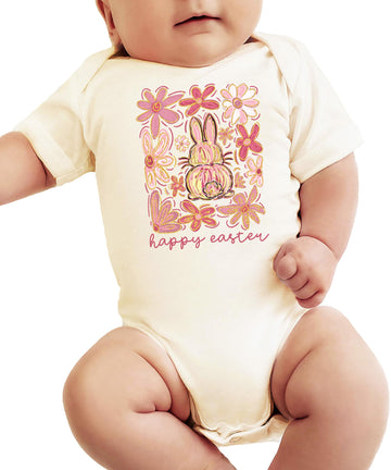Flat lay of boho Easter baby bodysuit with flowers and bunny graphic on natural fabric