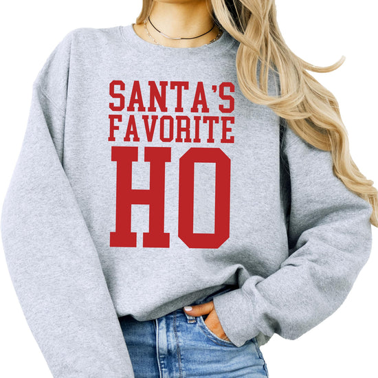 Woman wearing white Santa's Favorite Ho funny Christmas sweatshirt, front view