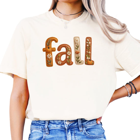Model wearing seafoam fall shirt with pumpkin and flower embroidery look