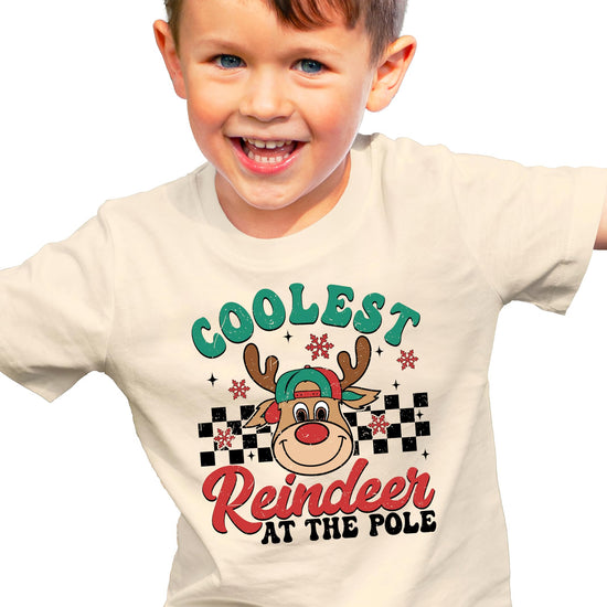 Front view of kids Christmas reindeer graphic tee in natural color, Coolest Reindeer at the Pole design