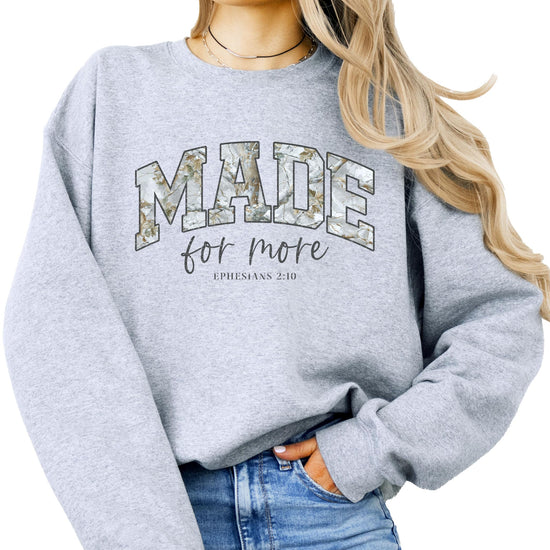 Close-up of Made for More inspirational text design on army green camo sweatshirt