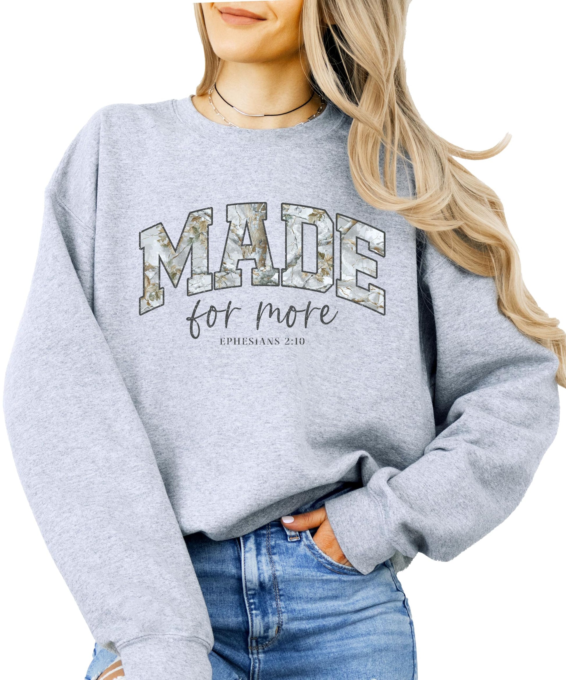 Close-up of Made for More inspirational text design on army green camo sweatshirt