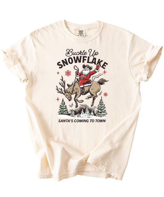 Model wearing Buckle Up Snowflake Santa western Christmas tee in ivory — casual holiday style