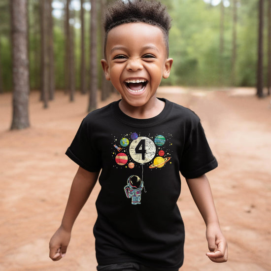 Detail shot of vibrant USA-printed astronaut and moon balloon graphic on black kids birthday shirt
