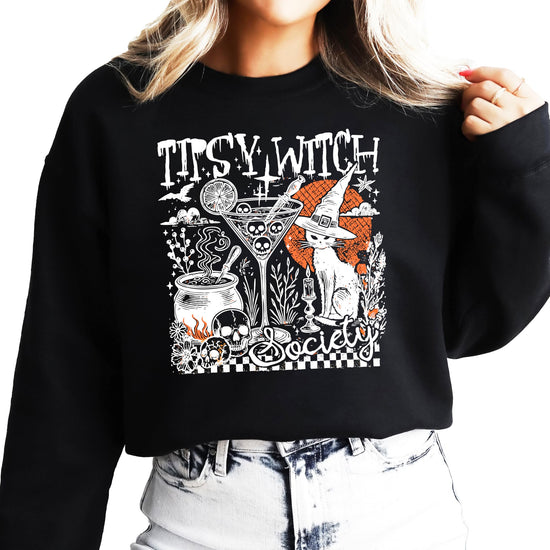 Front view of women's witchy Halloween crewneck sweatshirt with funny cocktail and black cat design