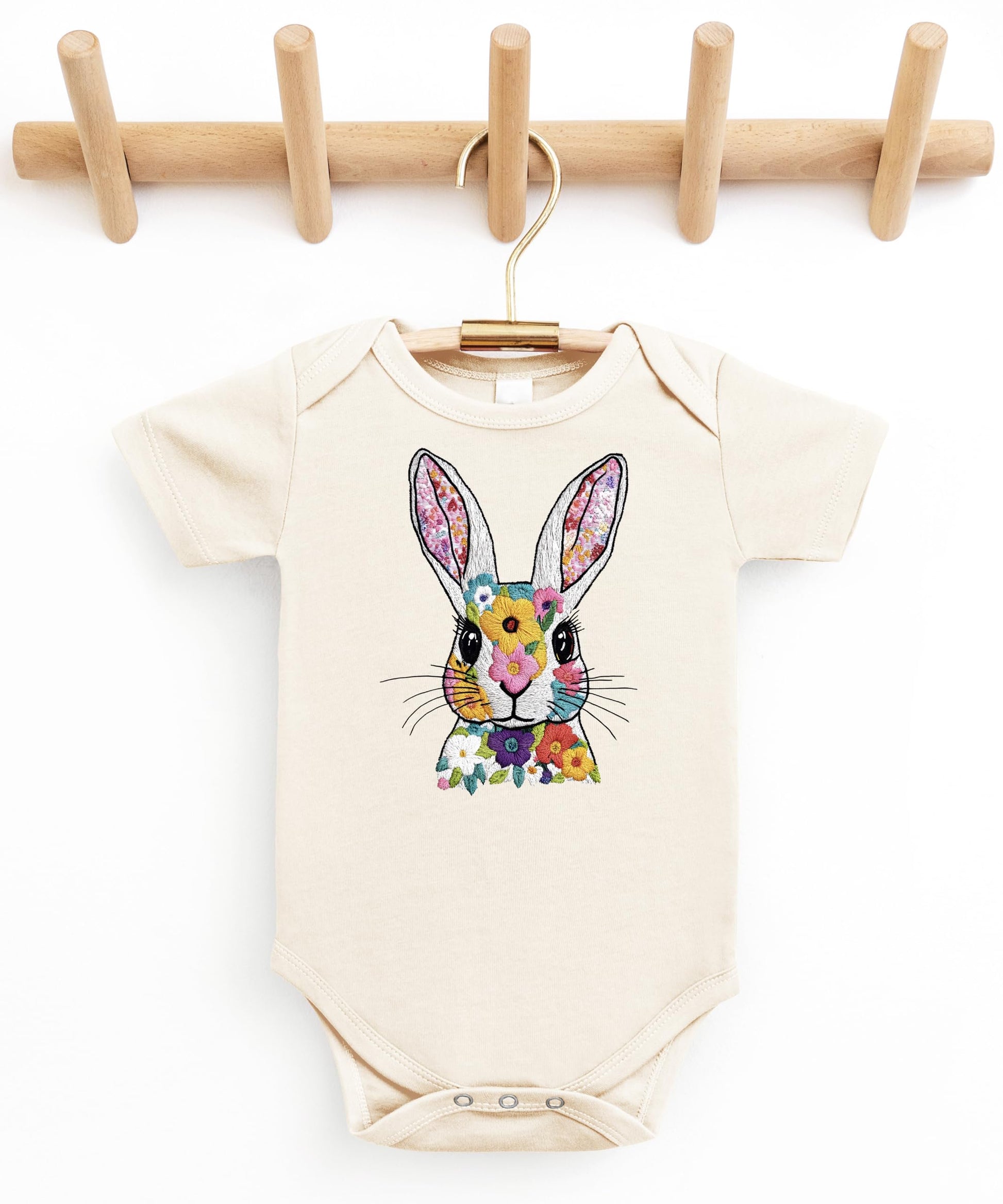 Side angle of baby wearing floral Easter rabbit onesie for springtime outfit