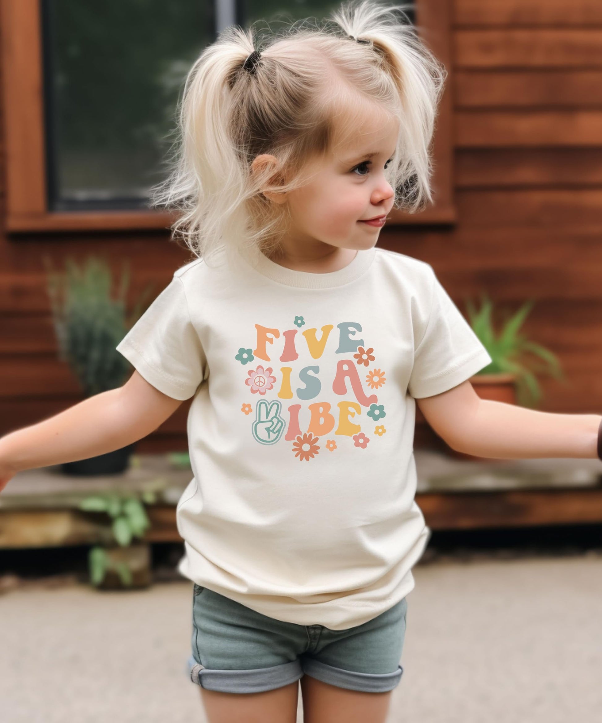 Close-up of Five is a Vibe retro-style birthday shirt print with floral and peace sign details for girls