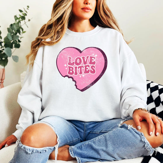 Flat lay of Love Bites heart crewneck sweatshirt — perfect for Galentine's Day gifting