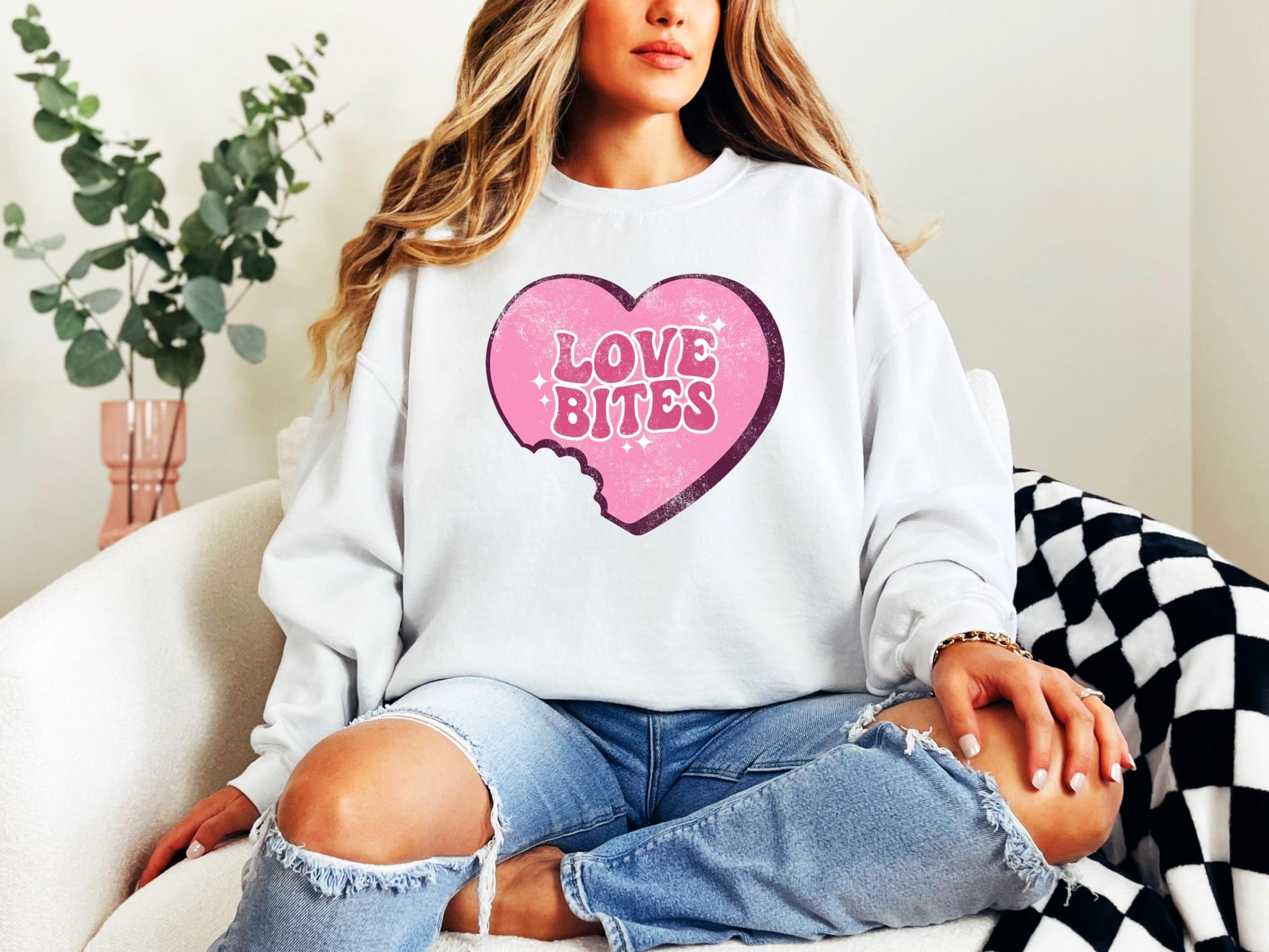 Flat lay of Love Bites heart crewneck sweatshirt — perfect for Galentine's Day gifting