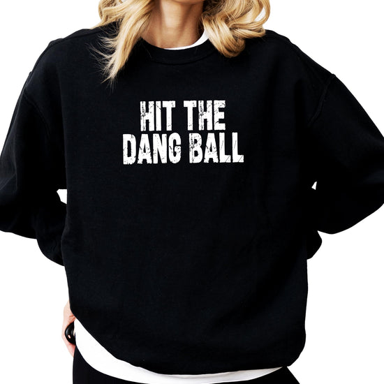 Detail shot of vintage-style Hit The Dang Ball graphic on cozy red women's sweatshirt