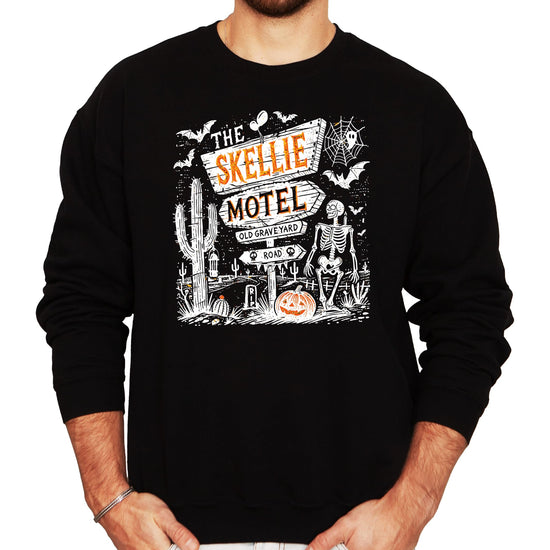 Front view of The Skellie Hotel Halloween sweatshirt showing full graphic print in warm fall tones