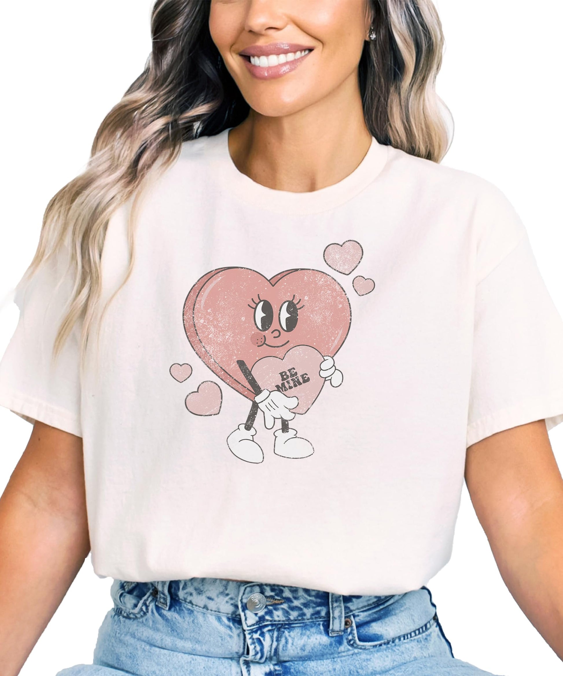 Detail shot of vibrant Be Mine heart graphic on pink kids Valentine's shirt