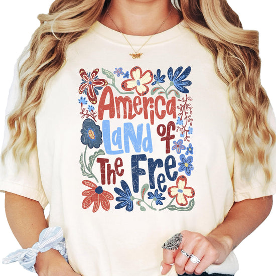 Close-up of floral patriotic graphic print on America Land of the Free women's tee