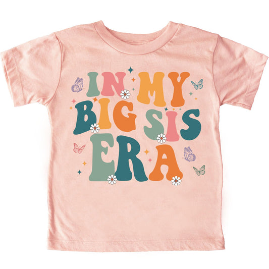 Peach youth tee with groovy wavy font reading In My Big Sis Era and butterfly graphic for girls