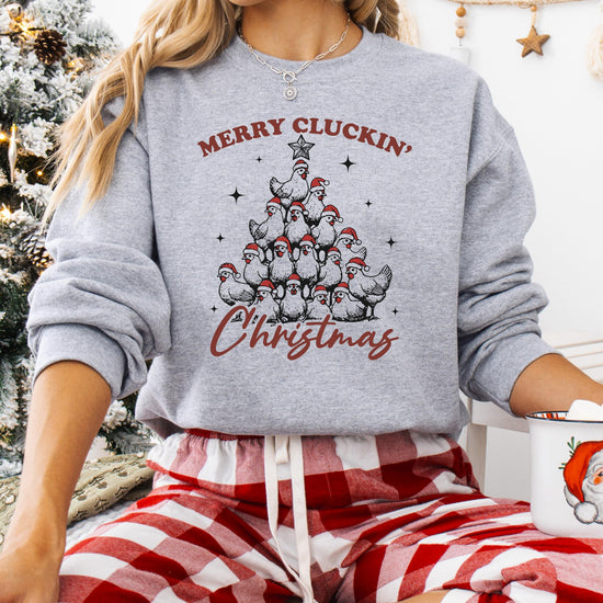 Detail shot of humorous chicken Christmas tree print on cozy white holiday pullover sweatshirt