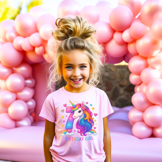 Young girl wearing pink 7th birthday unicorn shirt for birthday party