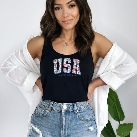 Model wearing white USA Est 1776 floral tank top showing relaxed fit and patriotic styling
