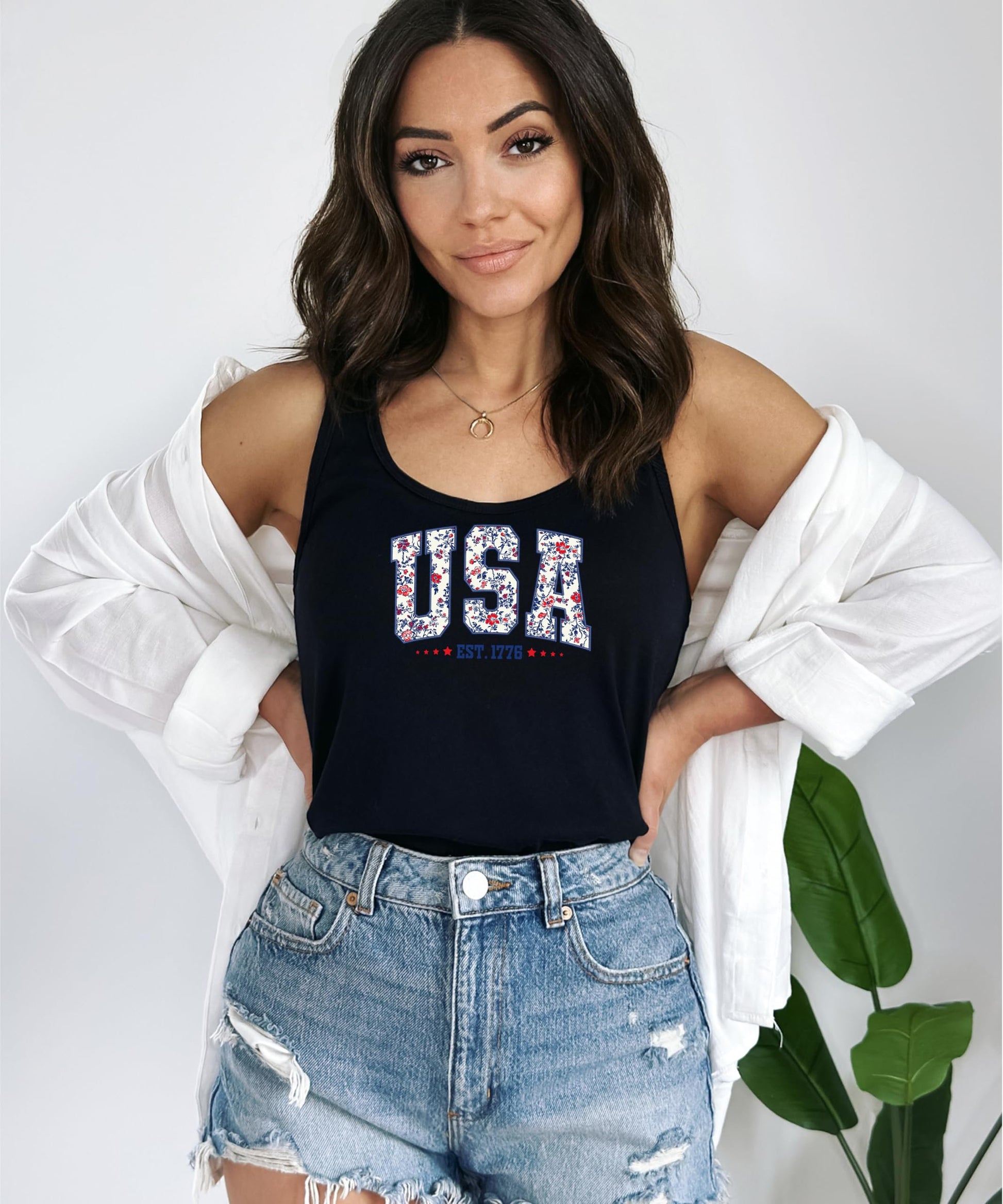Model wearing white USA Est 1776 floral tank top showing relaxed fit and patriotic styling