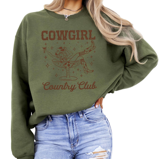 Model wearing Olive Loves Apple Cowgirl Country Club pullover sweatshirt in army green