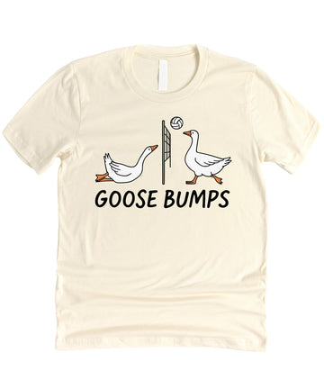 Front view of Goose Bumps Volleyball funny pun graphic shirt in peach on a flat lay background