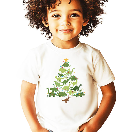 Close-up detail of dinosaur Christmas tree design with colorful lights on natural shirt fabric