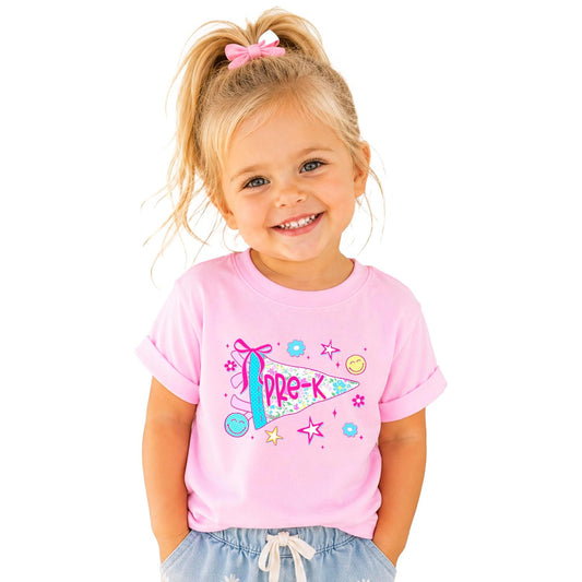 Little girl wearing a floral Pre-K pennant shirt — front view showing full graphic design on natural fabric
