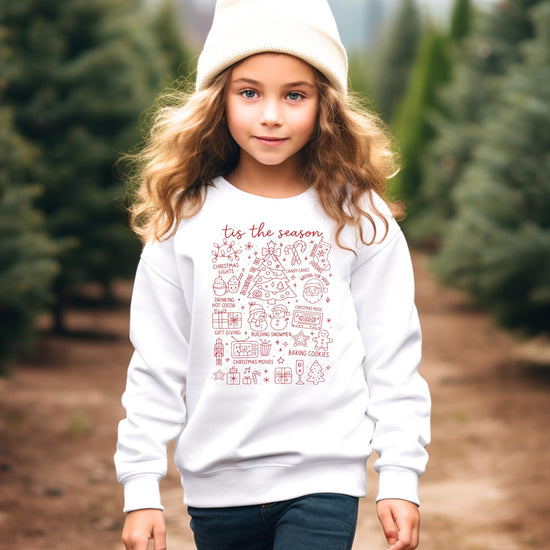 Detail shot of cozy white 'Tis the Season Christmas sweatshirt fabric and festive design