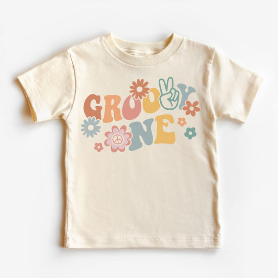 Toddler girl first birthday outfit featuring Groovy One daisy tee