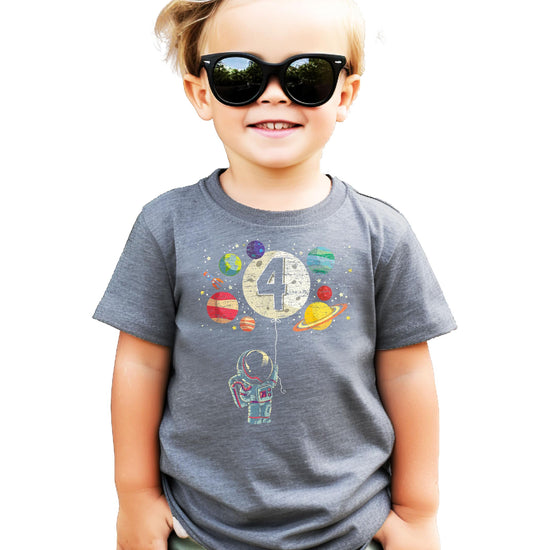 Child wearing black space-themed 4th birthday astronaut shirt with moon balloon design