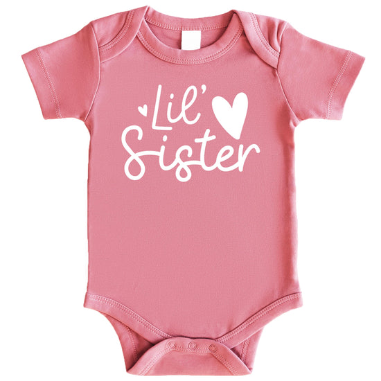 Baby girl wearing white-on-mauve Lil Sister Heart Bodysuit, front view