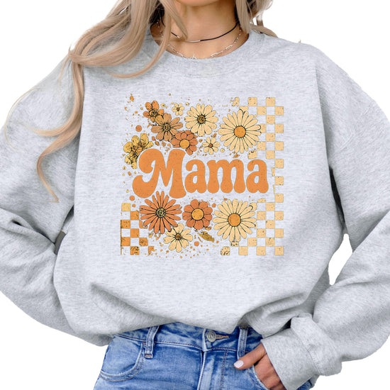 Detail shot of retro floral checkered mama print on cozy black crewneck sweatshirt
